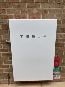 Teslar battery on brick wall