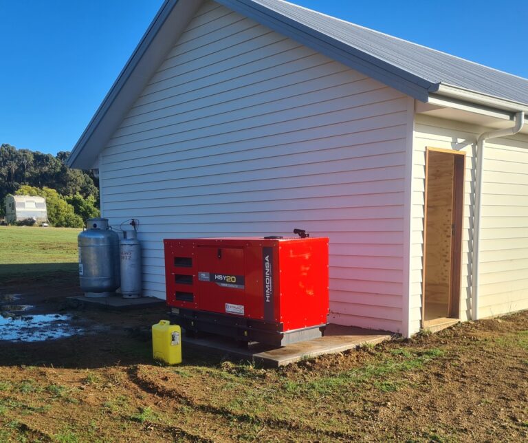 Generator on side of weatherboard building.